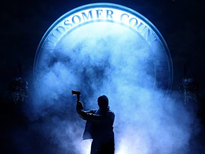 The Killings at Badger's Drift by .Manuel Harlan. An image of a person with an axe in shadows