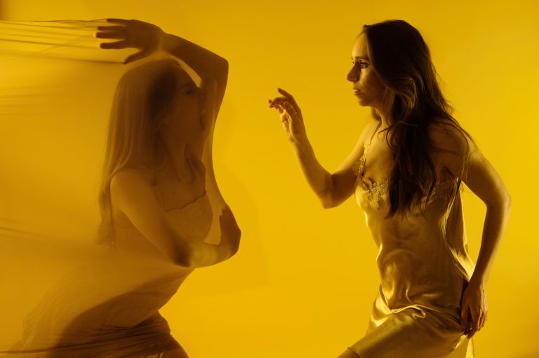 Image of a woman in cloth and another woman pointing to her